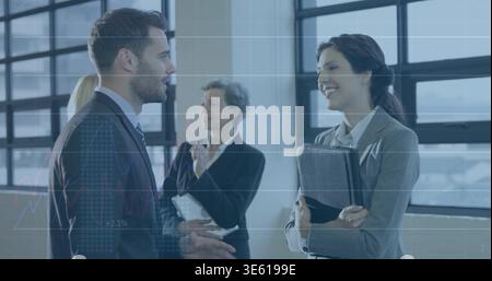 Talking bearded man gesturing while smiling at woman in suit near grid panes with portfolio tablet Stock Photo