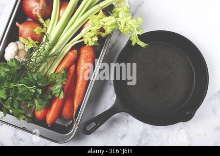 Cast-iron frying pan, baking tray with vegetables, for cooking ossobuco, top view, no people Stock Photo