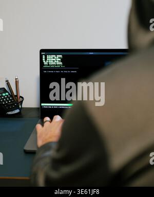Middle Aged Man Turns Hacker in Hoodie After Using Vibe Coding Command Line Interface Artificial Intelligence Large Language Model Assistant Concept Stock Photo