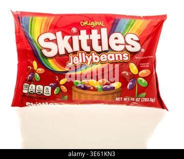 Winneconne, WI - 28 March 2026: A package of Skittles jelly beans candy on an isolated background. Stock Photo