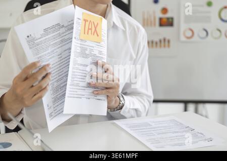 A professional displays tax forms with emphasis on financial details, highlighting the importance of accurate reporting Stock Photo