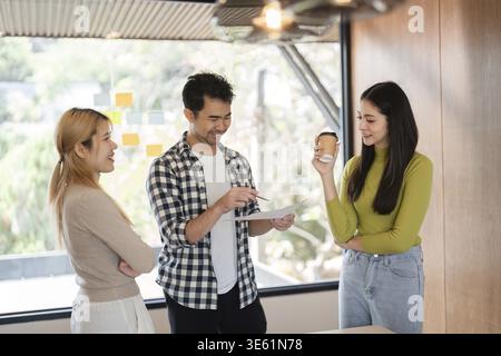 A group of diverse professionals engages in a collaborative discussion, sharing ideas and insights in a contemporary office setting Stock Photo
