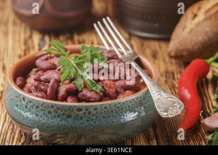 Red beans with tomatoes, garlic, spices and parsley. Lobio. Stewed legumes. Selective focus Stock Photo