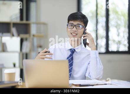 Confident businessman going over details of contract talking with partner on phone Stock Photo