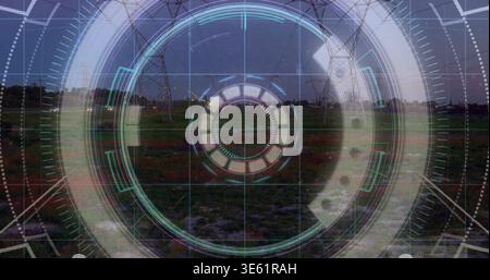 Displaying circular HUD overlay hovering at utility corridor dusk, with pylons and power lines Stock Photo