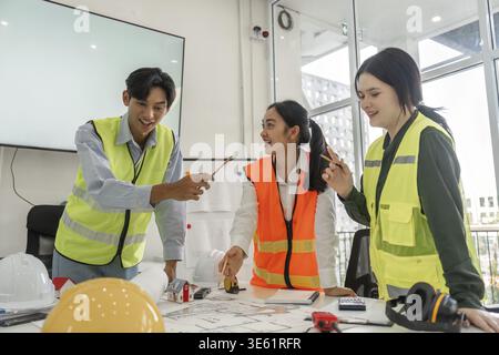 A lively construction team enthusiastically brainstorming ideas while discussing project plans, showcasing teamwork and creativity in a collaborative Stock Photo