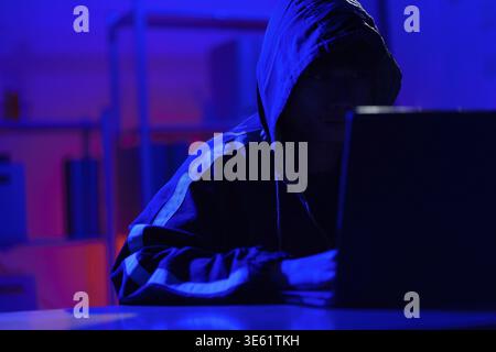 Hacker executing cyberattack representing data breach, system infiltration, and cybersecurity threat Stock Photo