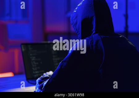 Hacker initiating cyberattack to infiltrate systems, steal data, and exploit cybersecurity weaknesses in digital networks Stock Photo