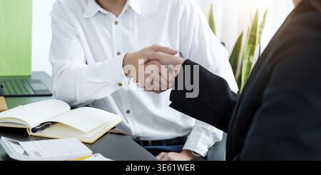 Close up of Business people shaking hands, finishing up meeting, business etiquette, congratulation, merger and acquisition concept Stock Photo