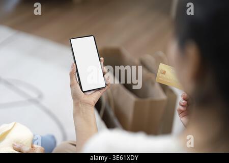 A mother and child using a smartphone app for online shopping, highlighting the convenience of digital purchases Stock Photo