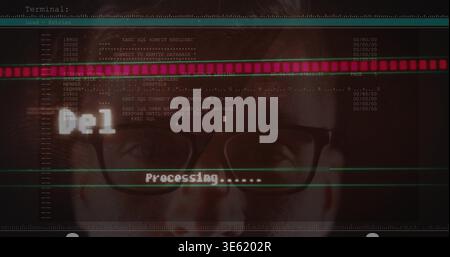 Staring man with black-framed glasses focusing on terminal at workstation, showing Processing Stock Photo