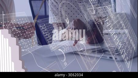 Working, two midage women in business shirts analyzing digital overlays at desk with laptop, papers Stock Photo