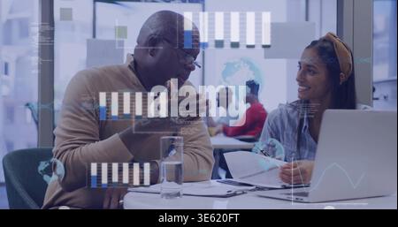 Mentoring senior in tan sweater and mentee reading papers at meeting, with laptop and data overlays Stock Photo