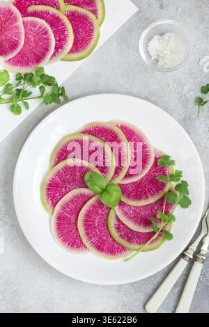 Food, Sliced watermelon radish on white plate. healthy vegan salad. top view Stock Photo