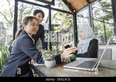 A diverse team engages in a productive discussion about sustainable practices, exploring innovative strategies to implement in their business operatio Stock Photo
