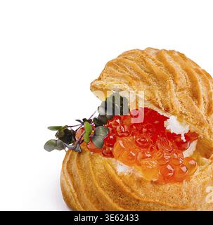 Food, A golden pastry shell is filled with rich cream and vibrant salmon roe, topped with fresh greens, showcasing an exquisite culinary creation perf Stock Photo