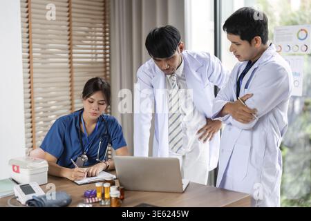 A team of medical professionals engaged in a collaborative analysis of patient data, focusing on teamwork and effective communication Stock Photo
