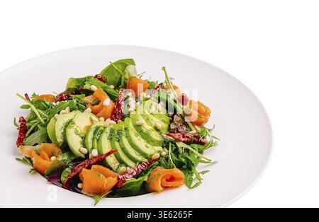 Food, A colorful salad features fresh greens topped with avocado slices, smoked salmon, sun-dried tomatoes, and toasted pine nuts. This vibrant dish i Stock Photo