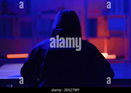 Hacker executing cyberattack representing data breach, system infiltration, and cybersecurity threat Stock Photo
