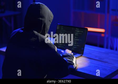 Hacker executing cyberattack representing data breach, system infiltration, and cybersecurity threat Stock Photo