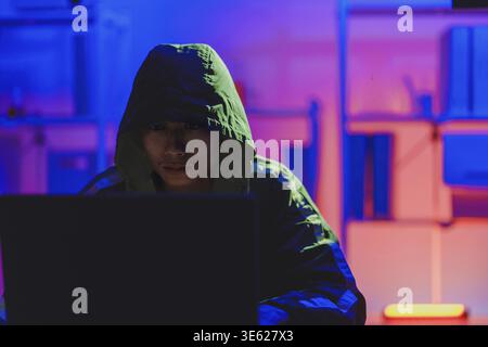 Hacker executing cyberattack representing data breach, system infiltration, and cybersecurity threat Stock Photo