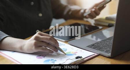 Business man investment consultant analyzing company annual financial report balance sheet statement working with documents graphs. Concept picture of Stock Photo