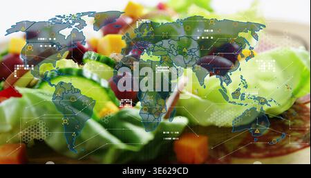 Displaying colorful salad plate with lettuce, cucumber, olives on wooden table, world map overlay Stock Photo
