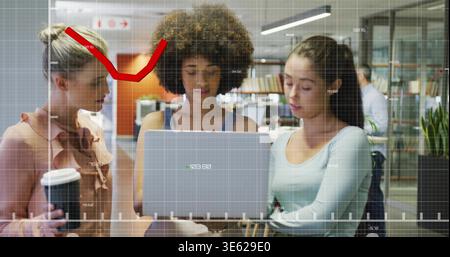Collaborating team leaning over laptop in office with coffee, in office attire, showing overlay Stock Photo