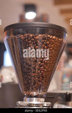 Coffee beans in grinder at cafe during day Stock Photo