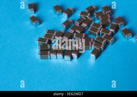 Surface mount ceramic capacitors on blue background Stock Photo