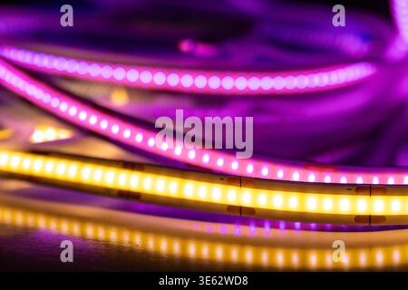 Colorful LED strip lights with reflections on dark surface Stock Photo