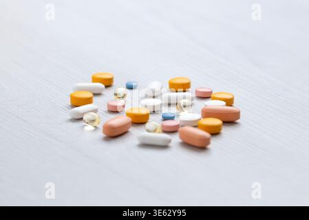 Assorted pills on surface with shallow depth of field, healthcare and pharmaceutical concept Stock Photo
