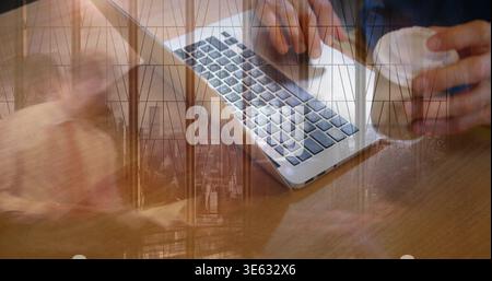 Typing dark-sleeved hands on silver laptop on wooden table, holding coffee cup with window overlay Stock Photo