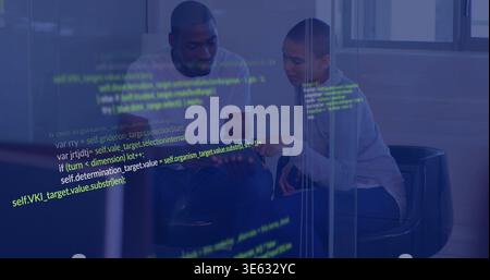 Responding to projected code, two colleagues in tee and sweater pointing at tablet in glass office Stock Photo