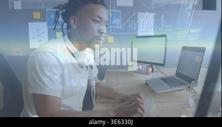 Data analyst typing on keyboard at desk, activating holographic UI updating charts for analysis Stock Photo
