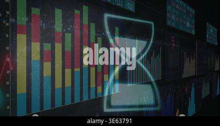 Glowing translucent cyan hourglass icon overlaying dark monitoring wall, showing stacked bar chart Stock Photo