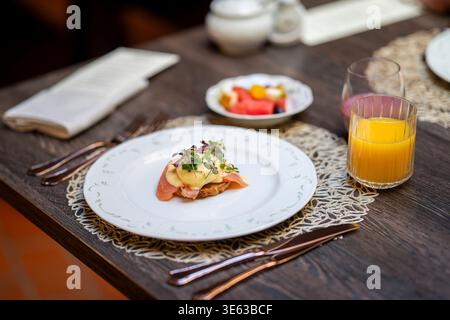 Eggs Atlantic with runny poached egg, smoked salmon and creamy hollandaise sauce on toasted bread. Gourmet brunch dish featuring poached egg. Stock Photo