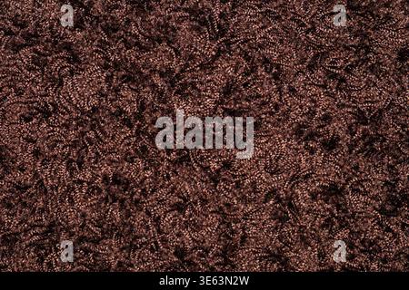 A close-up view of a brown fabric carpet with a long pile texture. Stock Photo