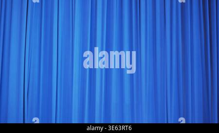 Vibrant blue theatrical curtain with soft vertical folds. Abstract fabric texture background. Stock Photo