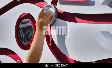 Hand Pressing Button on Interactive Sports Display Stock Photo