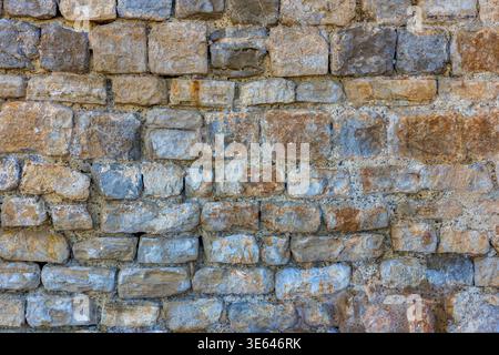 Ancient Stone Wall Background on a Rocky Peninsula Coastline, Spain Stock Photo