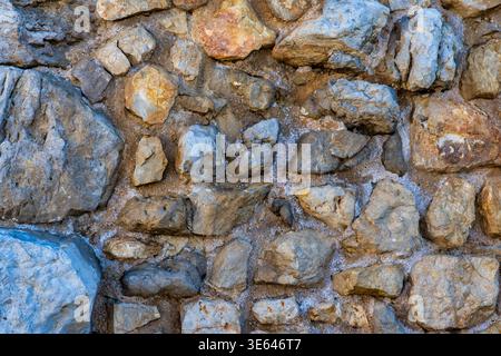 Rustic Stone Wall Background with Random Size Stones, Spain Stock Photo