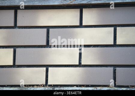 An example of a facing panel imitating brickwork in shades of grey. Horizontal photo Stock Photo