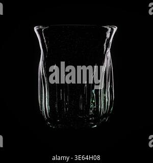 Artisan hand-blown glass tumbler, by artist Nadia Festuccia. Studio shot using dark field lighting on black background, Waterloo, Ontario, April 2026 Stock Photo