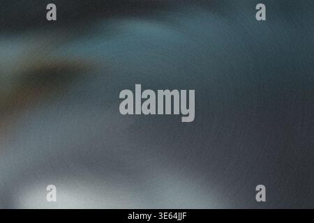 Blurry abstract image featuring shades of blue and gray in a gradient background with no distinct objects or features visible Stock Photo