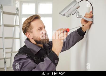 Serious Workers Installing Surveillance Camera Stock Photo