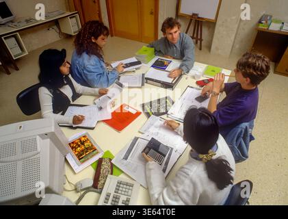 1990s School Study Group Class Male teacher and teenagers 13-15 years work together in a school classroom with 90’s computer technology Stock Photo