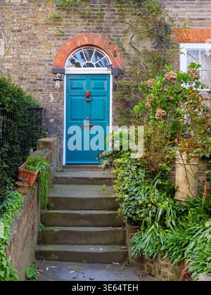 Traditional wooden door and front garden of terraced house in Flask Walk, Hampstead, London, UK Stock Photo