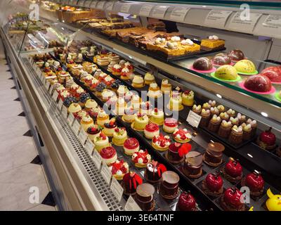 Sweet cakes and deserts at the patisserie counter inside the Food Hall at Selfridges, London, UK Stock Photo