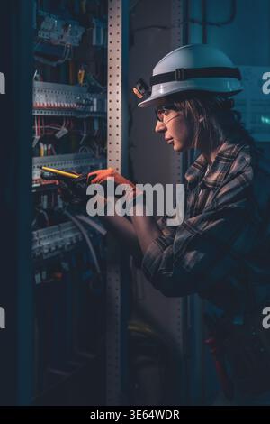 Technical specialist inspecting electrical system with voltage tester. Engineering control. Stock Photo